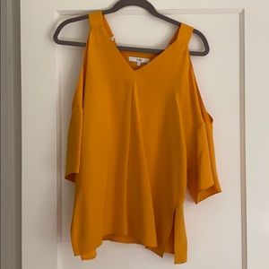 Tibi “cold shoulder” shirt